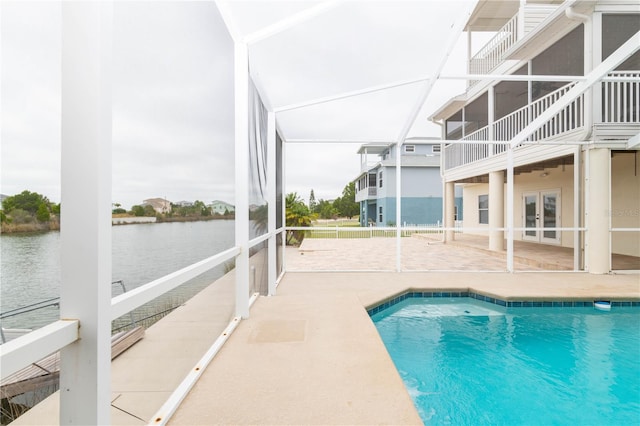 view of swimming pool with french doors, a water view, and a patio area