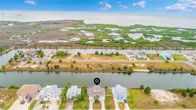 drone / aerial view featuring a water view and a residential view