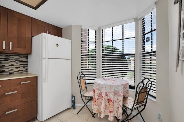 dining area featuring light tile patterned floors and plenty of natural light