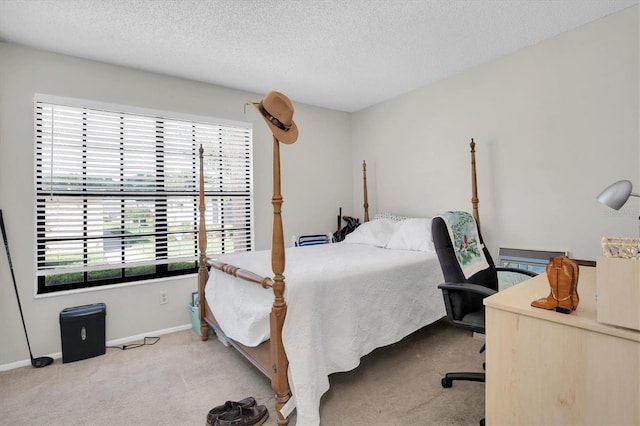 carpeted bedroom featuring a textured ceiling