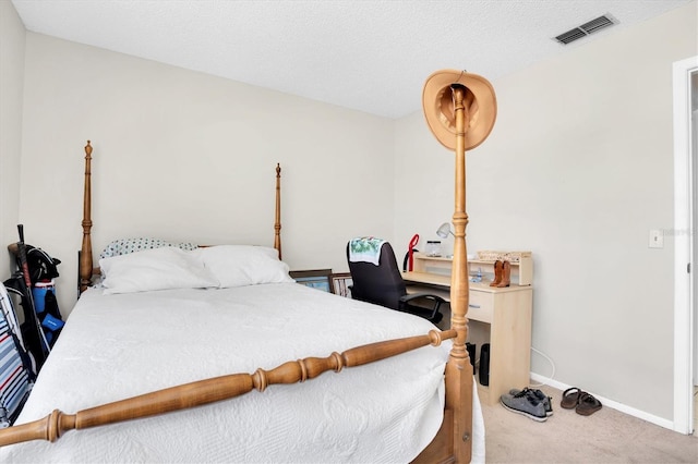 bedroom with carpet flooring and a textured ceiling