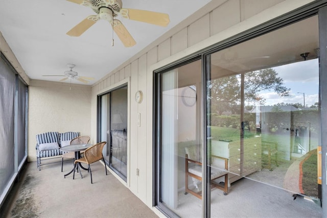 sunroom / solarium featuring ceiling fan