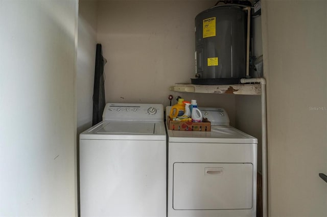 laundry area featuring electric water heater and washer and clothes dryer