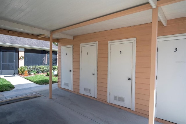 view of exterior entry featuring a patio