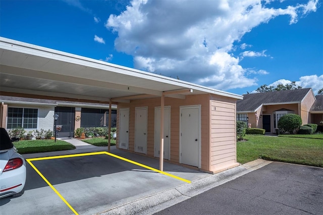 garage with a carport and a yard