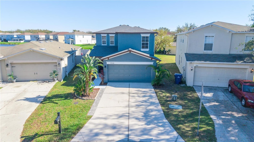 front facade featuring a front yard and a garage