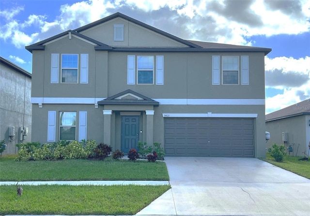 view of front of house featuring a garage and a front lawn