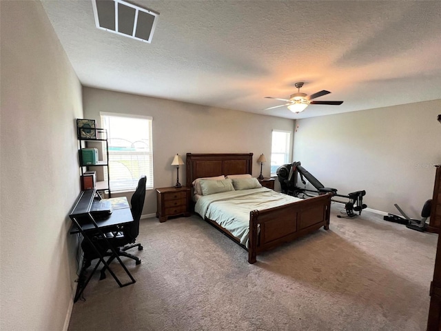 bedroom with light colored carpet, multiple windows, and ceiling fan