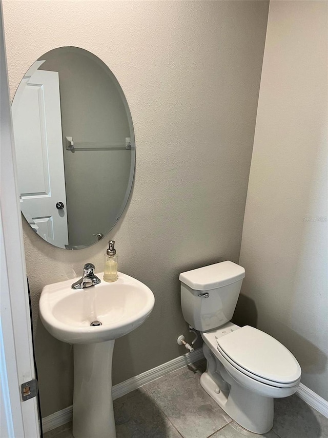 bathroom with tile patterned floors and toilet