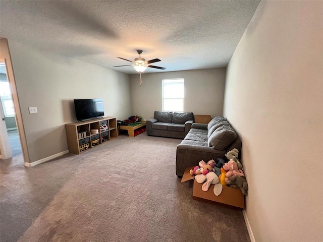 carpeted living room featuring a textured ceiling and ceiling fan