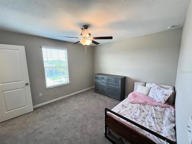 bedroom featuring ceiling fan, carpet, and a textured ceiling