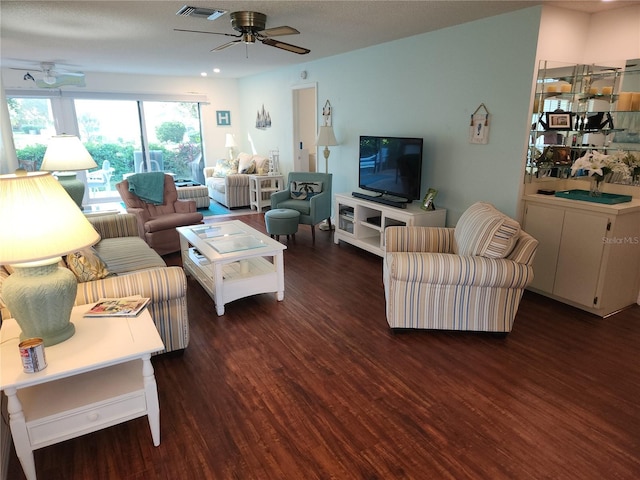 living room featuring ceiling fan and dark hardwood / wood-style flooring