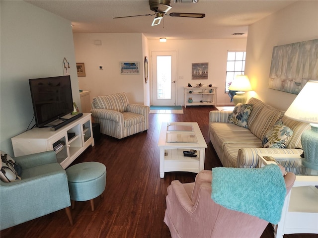 living room with ceiling fan and dark hardwood / wood-style flooring