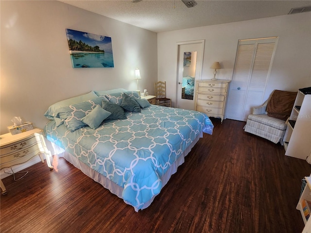 bedroom featuring a textured ceiling, a closet, and dark wood-type flooring