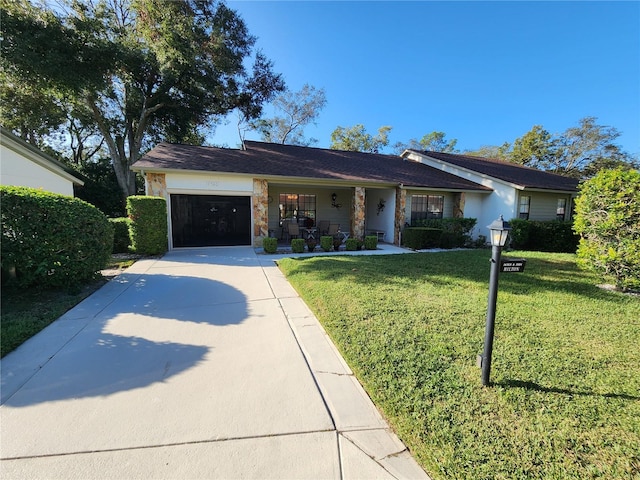 ranch-style house with a front lawn, a porch, and a garage