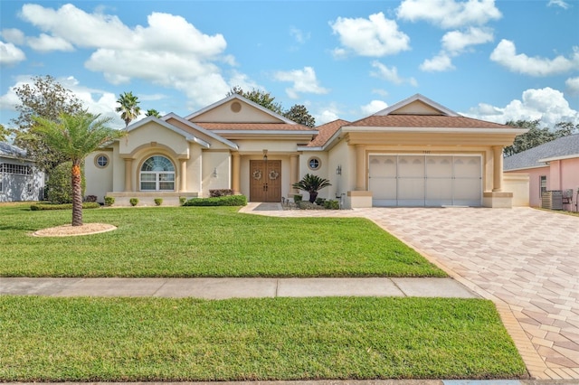 view of front of house with a front yard and a garage