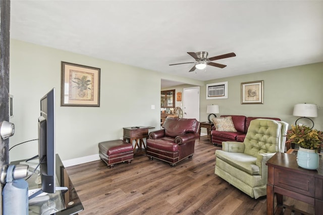 living room featuring dark hardwood / wood-style floors and ceiling fan