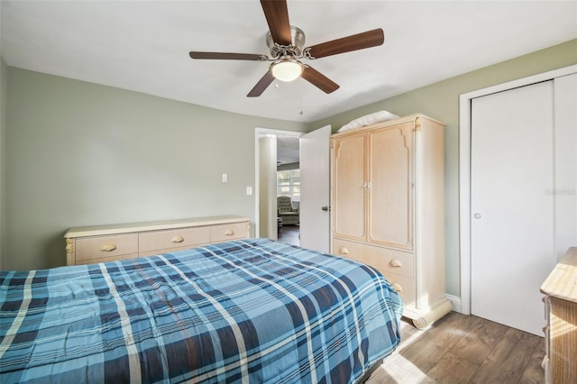 bedroom featuring hardwood / wood-style flooring, ceiling fan, and a closet