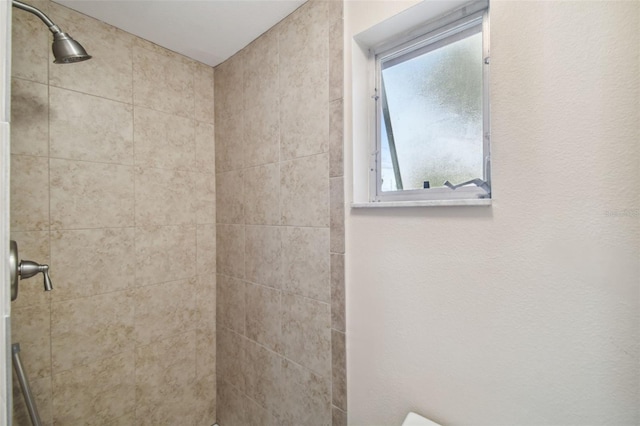 bathroom with tiled shower