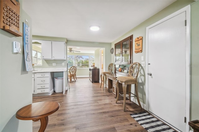 kitchen with white cabinets and light hardwood / wood-style flooring