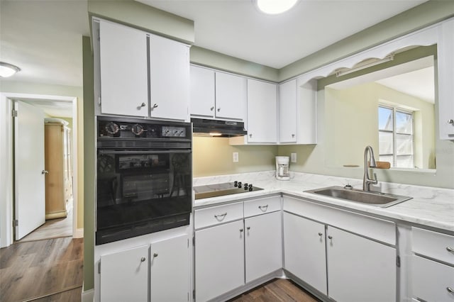 kitchen with black appliances, dark hardwood / wood-style floors, and white cabinets