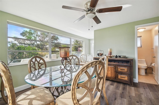 dining space featuring ceiling fan and dark hardwood / wood-style floors