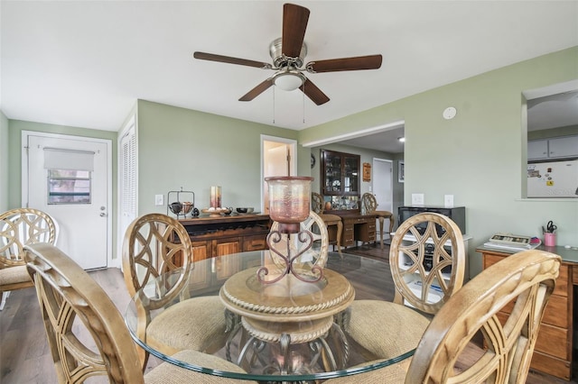 dining area featuring dark wood-type flooring and ceiling fan