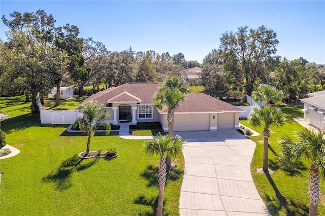 view of front of property featuring a front yard and a garage