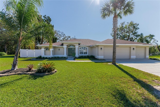 view of front of home with a garage and a front lawn