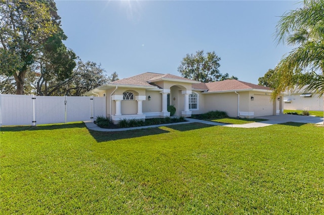 mediterranean / spanish-style house with a garage and a front lawn