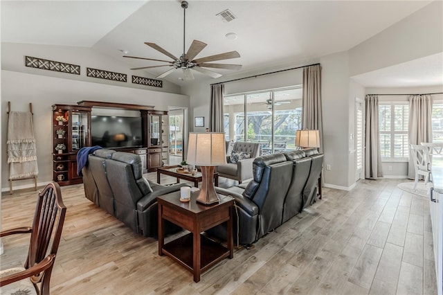 living room with light hardwood / wood-style flooring and lofted ceiling