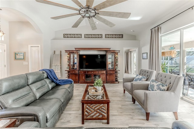 living room with plenty of natural light, lofted ceiling, and light hardwood / wood-style flooring