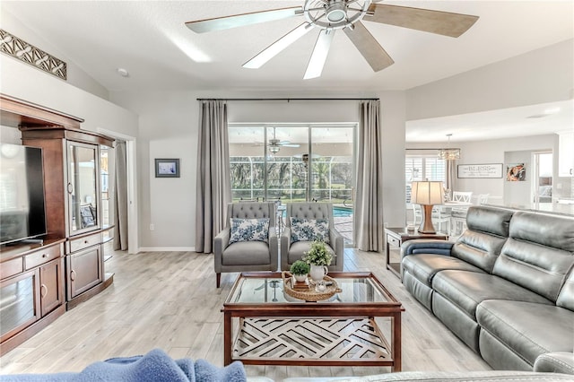 living room featuring vaulted ceiling and light hardwood / wood-style flooring