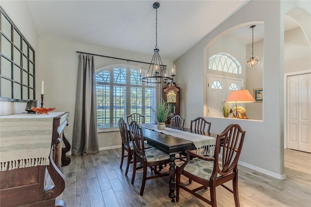 dining room featuring an inviting chandelier, a healthy amount of sunlight, and wood-type flooring