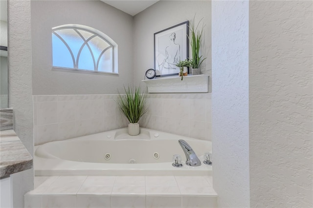 bathroom with vanity and a relaxing tiled tub