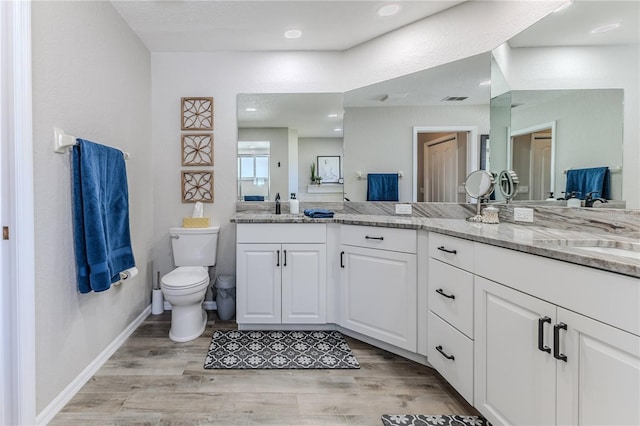 bathroom with vanity, hardwood / wood-style flooring, and toilet