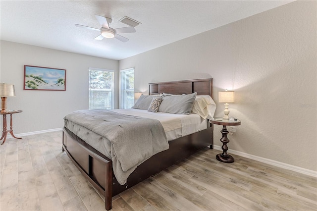 bedroom with ceiling fan and light hardwood / wood-style floors