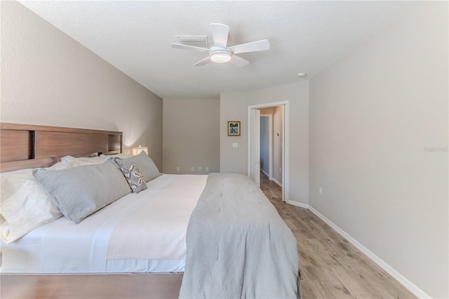 bedroom featuring light wood-type flooring and ceiling fan