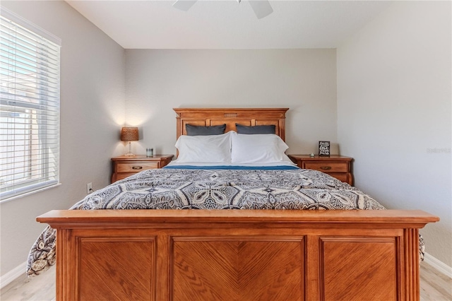 bedroom with ceiling fan and multiple windows