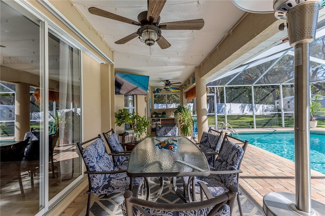 sunroom / solarium with ceiling fan and a swimming pool