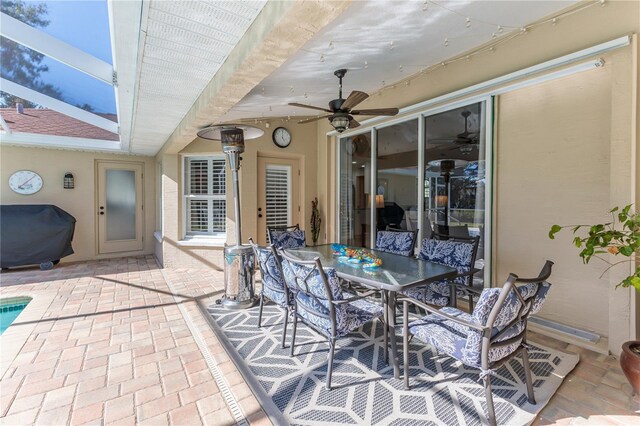 view of patio featuring ceiling fan and a grill