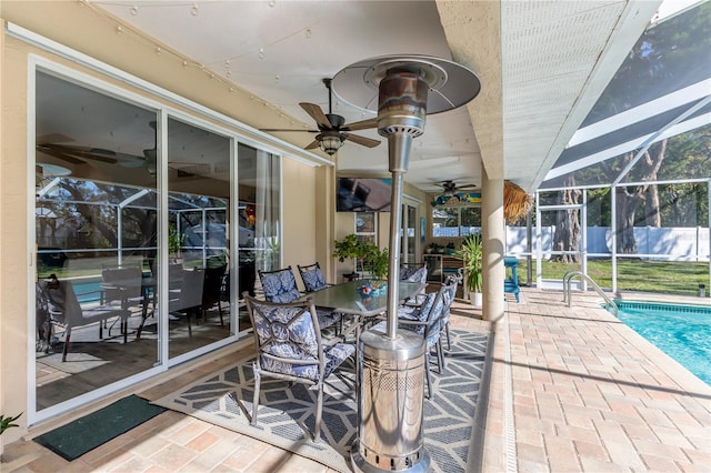 view of patio / terrace featuring a fenced in pool and glass enclosure