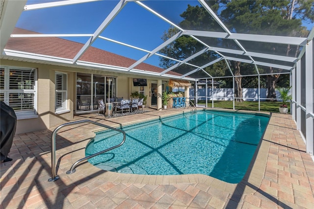 view of swimming pool with glass enclosure and a patio