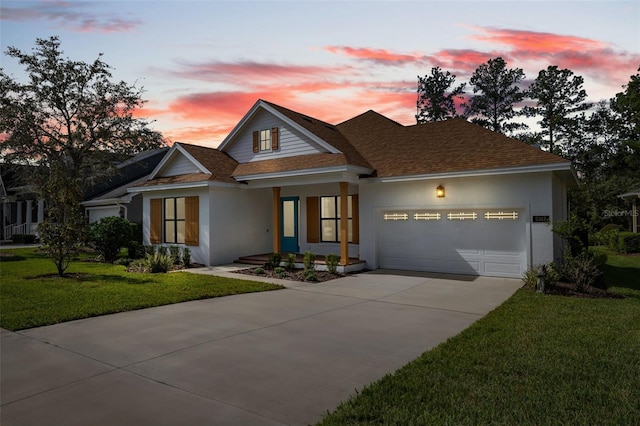 view of front of house with a garage and a yard