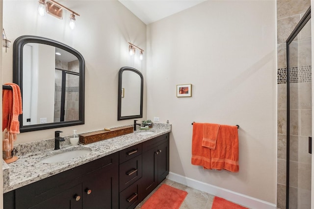 bathroom featuring vanity, tile patterned floors, and a shower with door