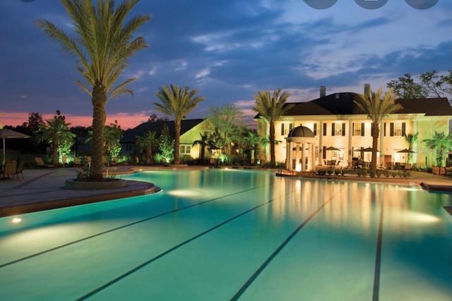 view of pool at dusk