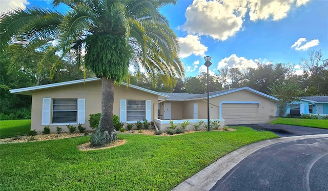 ranch-style house with a garage and a front lawn