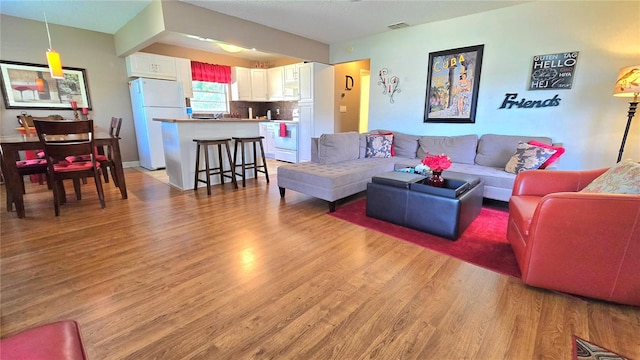 living room with light hardwood / wood-style flooring