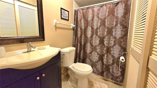 bathroom with tile patterned flooring, vanity, and toilet