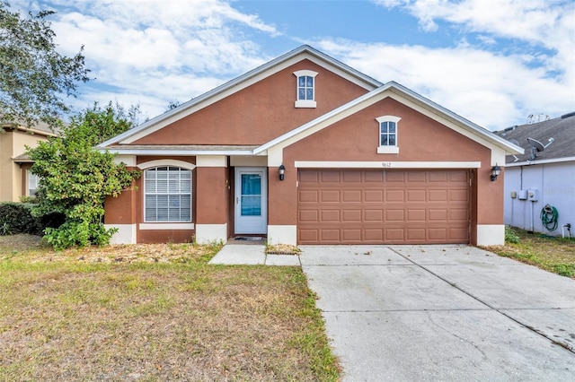 view of front of property with a garage and a front yard